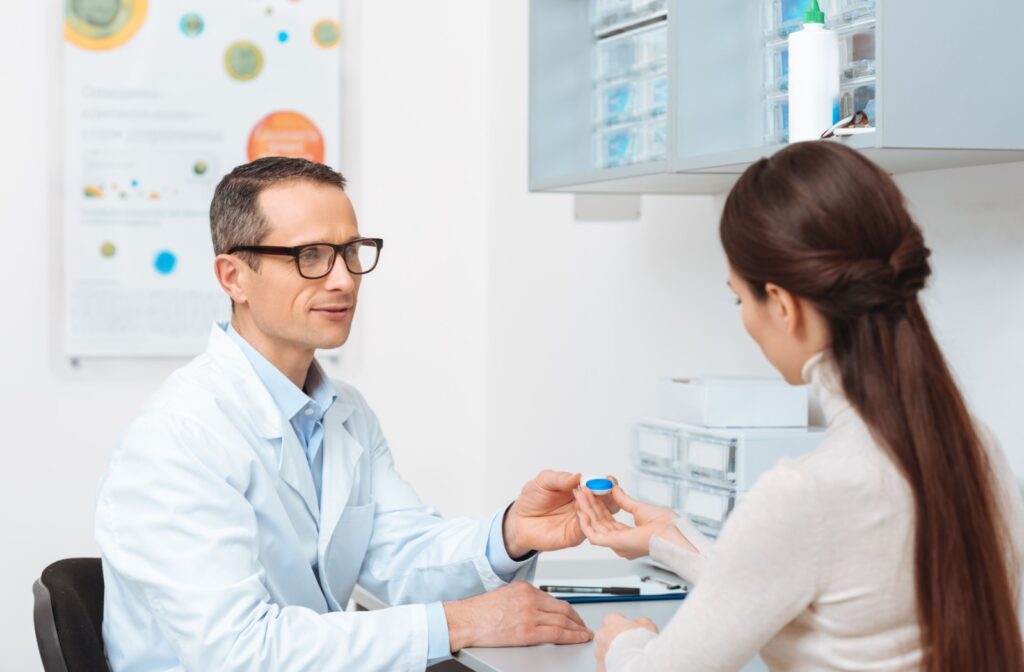 An optometrist talking to their patient about proper contact lens wear and care.