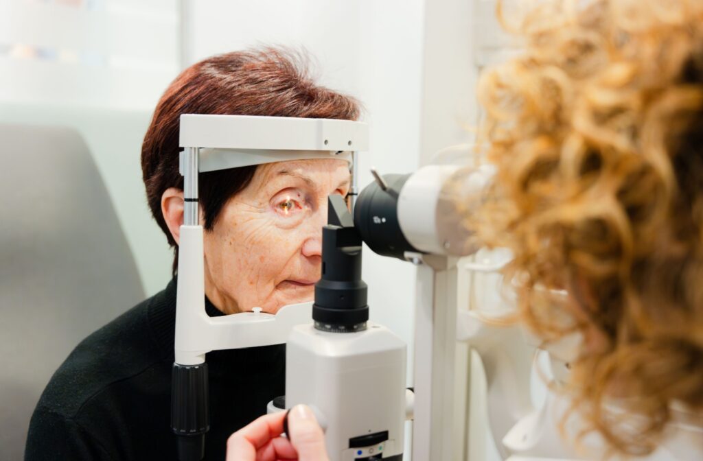 A person having their eyes examined for signs of cataracts during a comprehensive eye exam with their optometrist